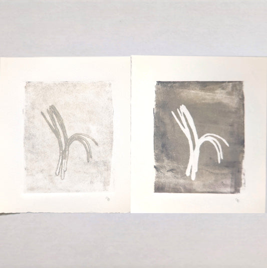 Original Fine Art Monoprint Diptych Collection by Carrie Bergey displayed in white ornate frames above a beige sofa, showcasing pine needle-inspired abstract forms.