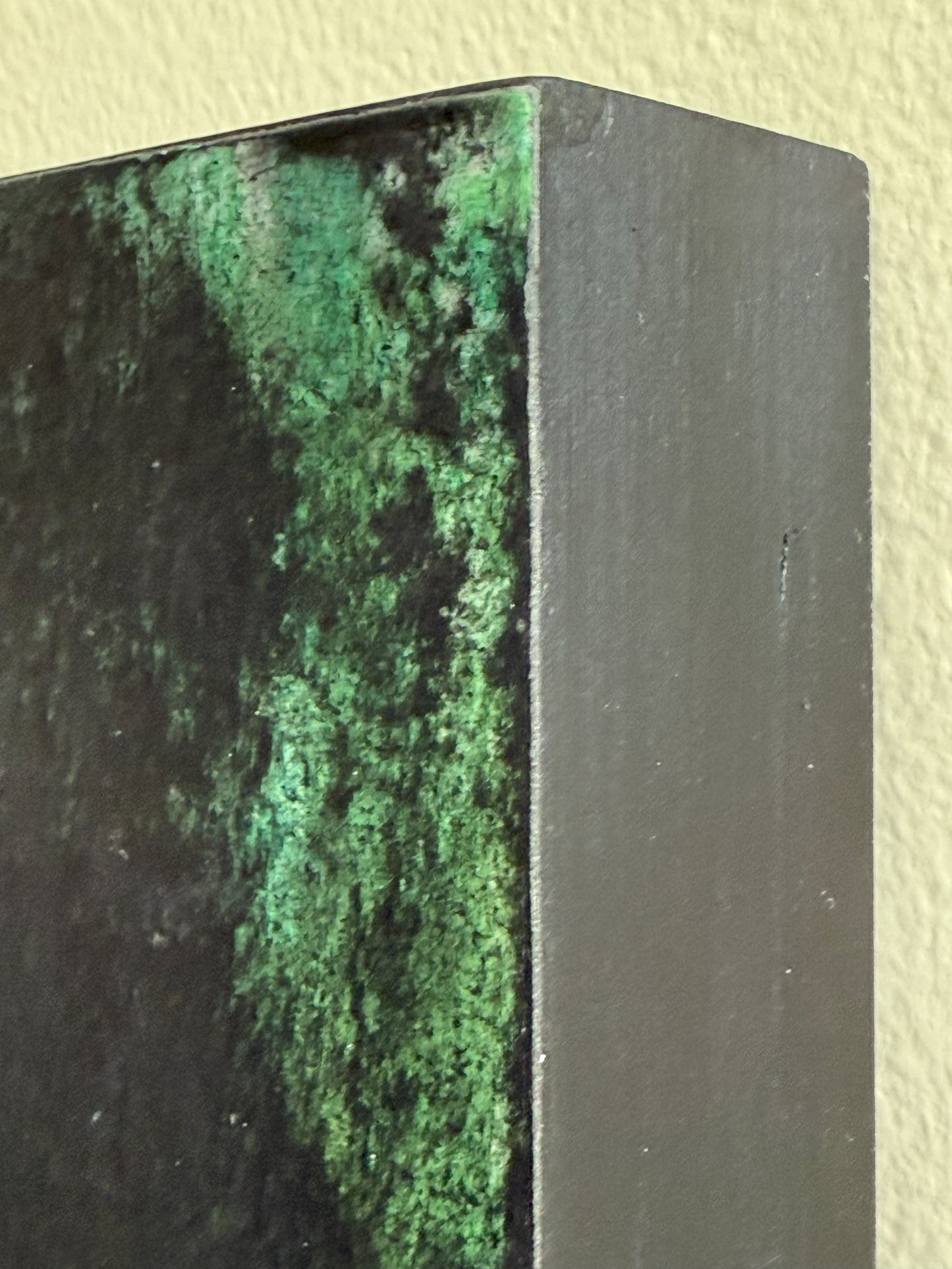 Corner detail of Carrie Bergey's original artwork showing rich green textures and professional gallery-wrapped canvas edge.