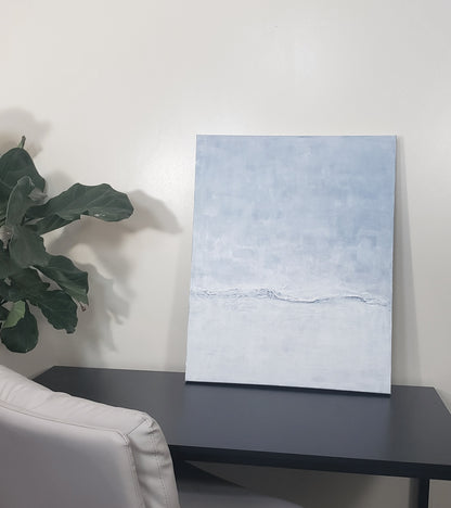 Restorative Roller Original Fine Art Painting by Carrie Bergey leaning on a desk, adding calming oceanic energy to a contemporary workspace setting.