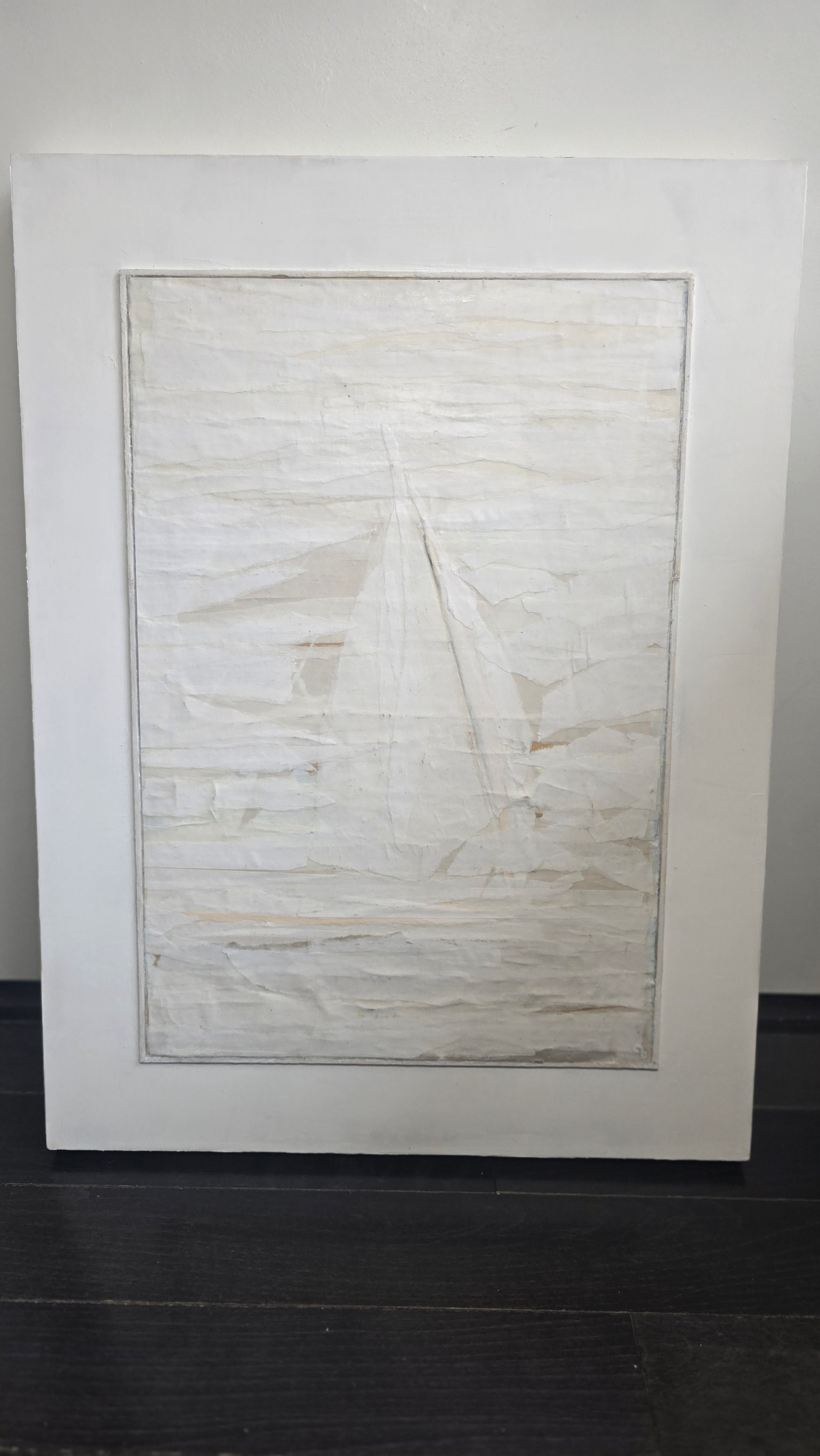 Framed Beyond Tiburon - Sailing original mixed media painting by Carrie Bergey leaning against a wall, showcasing its neutral tones and layered design.