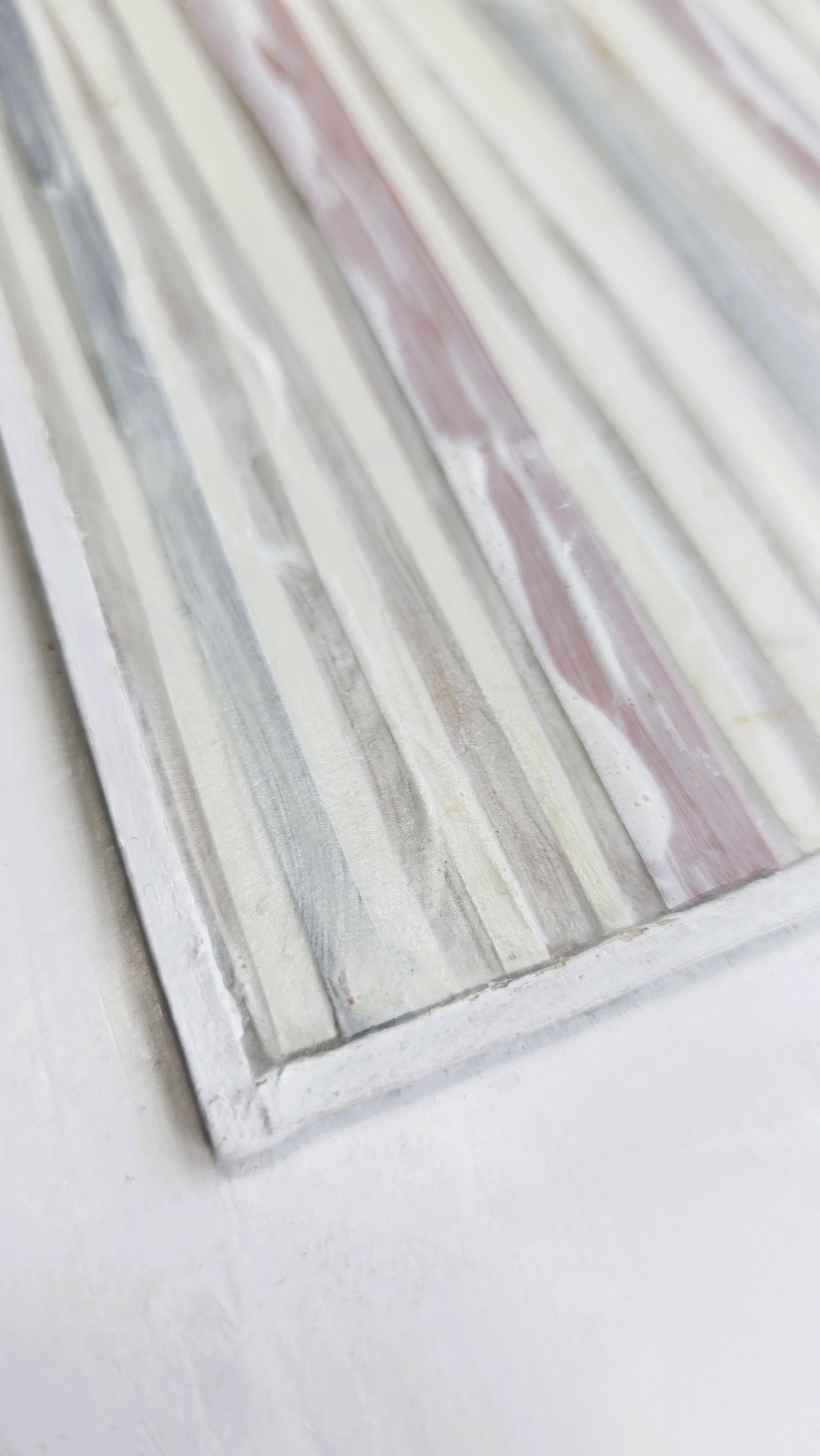Angled close-up of In-Line Minimalist Mixed Media Art by Carrie Bergey showing raised acrylic textures and layered paper and wood elements.