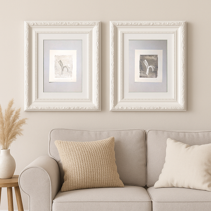 Original Fine Art Monoprint Diptych Collection by Carrie Bergey displayed in white ornate frames above a beige sofa, showcasing pine needle-inspired abstract forms.